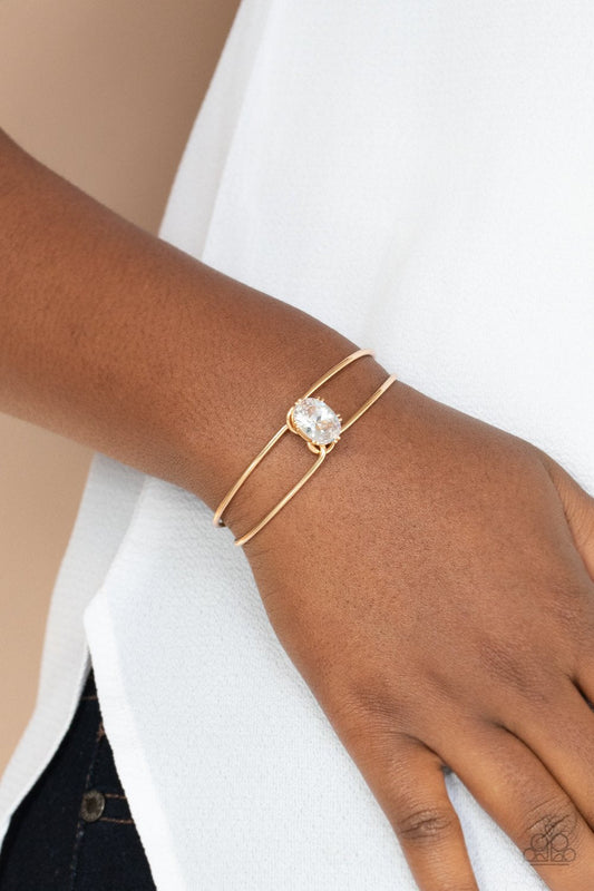 GLOW No Mercy - Gold Wire & Oversized White Rhinestone Paparazzi Cuff Bracelet
