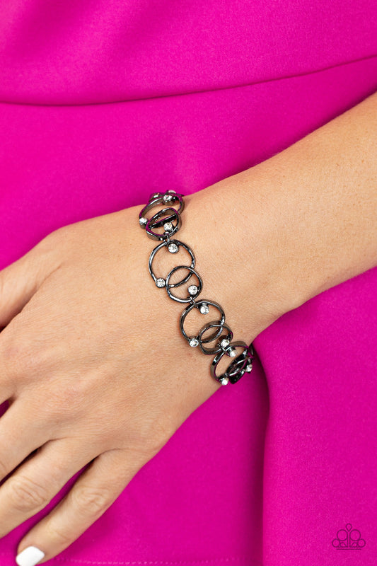 The Universe Revolves around Me - Gunmetal Asymmetrical Overlapping Rings & White Rhinestone Paparazzi Adjustable Bracelet