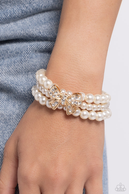 How Do You Do? - Gold Bow & White Pearl Paparazzi Stretch Bracelet