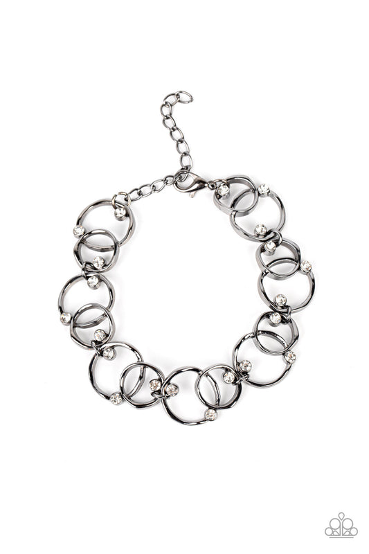 The Universe Revolves around Me - Gunmetal Asymmetrical Overlapping Rings & White Rhinestone Paparazzi Adjustable Bracelet