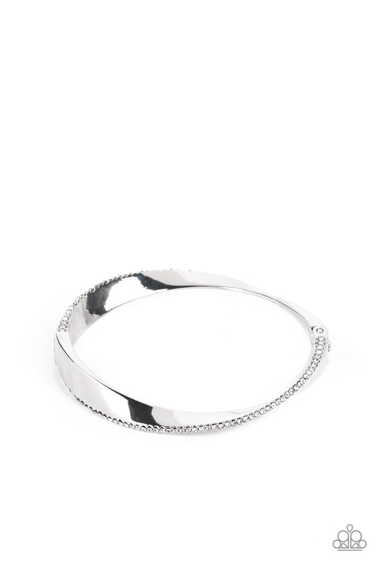 Artistically Adorned - White Dainty Rhinestone Encrusted Oversized Warped Paparazzi hinge Bracelet